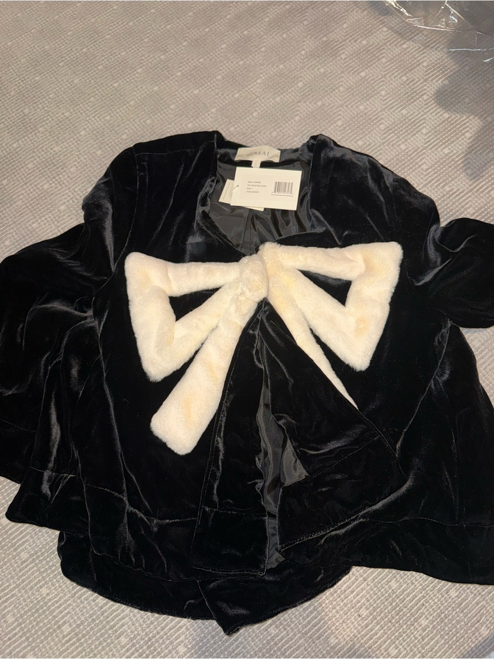 THE GREAT. Black Velvet Jacket with Cream Faux-Fur Bow Accent